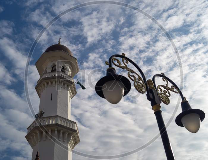 Minaret Kapitan Keling Mosque With The Street Lamp Under Blue Sky
