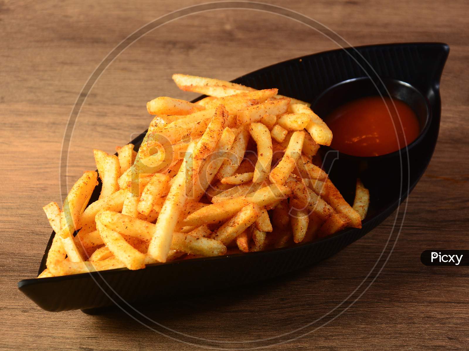 Tasty Spicy Peri Peri French Fries With Tomato Ketchup Served In A Bowl Over A Rustic Wooden Background, Selective Focus