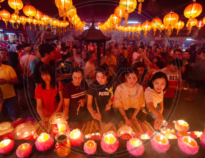 Chinese Devotees Light Up Candle At Goddess Of Mercy Temple During Chinese New Year