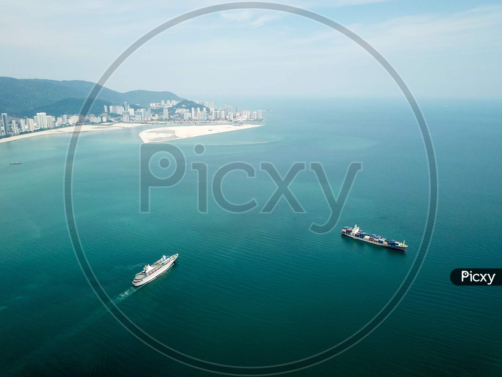 Cruise Ship Move At Penang Sea. Back Is Gurney Wharf Reclamation Land