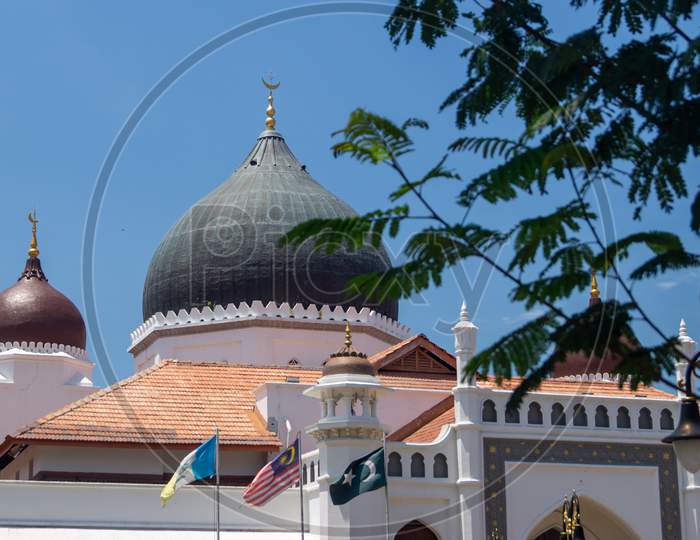 Masjid Kapitan Keling Mosque With Green Leaves