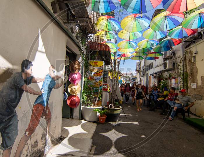 Mural Art At Street Near Armenian Street With Colorful Umbrella Hang At Sky