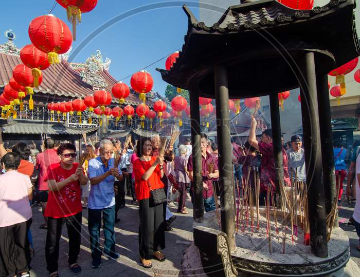 Chinese Pray At Goddess Of Mercy Temple In Bright Sunny Day