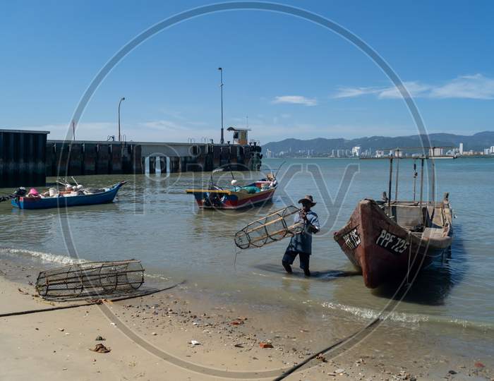 Fisherman Carry Fish Trap