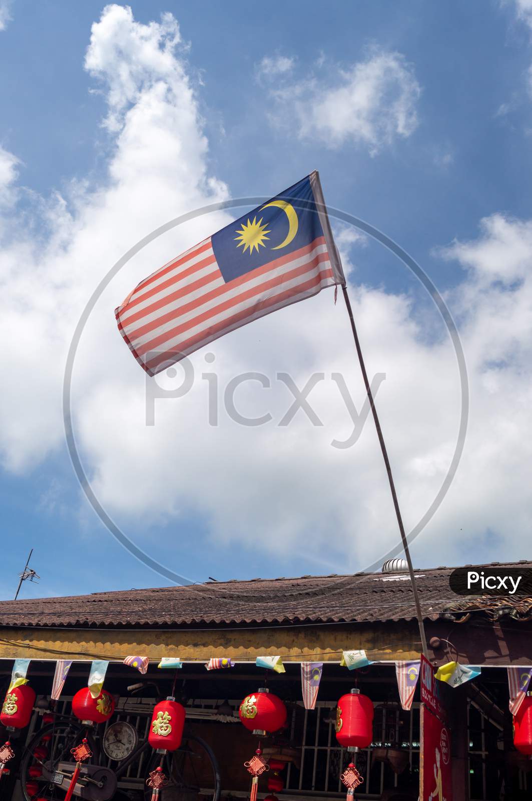 Malaysia Flag Waving On Rooftop
