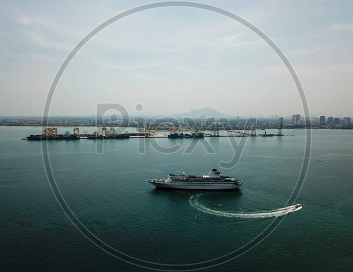 A Boat Move Near Cruise Ship. Background Is Container Terminal