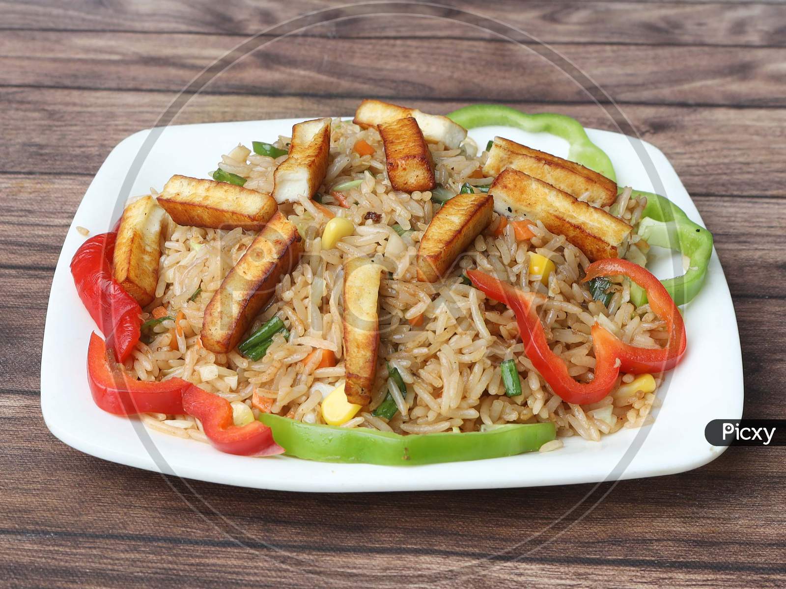 Healthy And Tasty Paneer Fried Rice Made Of Rice, Mixed Veggies And Paneer, Served In Bowl Over A Rustic Wooden Background, Indo Chinese, Indian Cuisine, Selective Focus