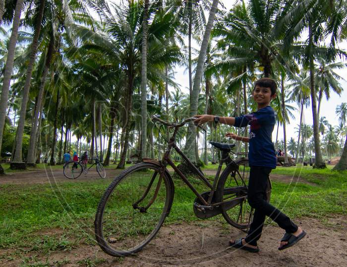 Kids Walk With Antic Bicycle At Coconut Farm