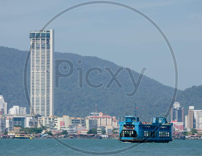 Blue Ferry With Komtar Building Background