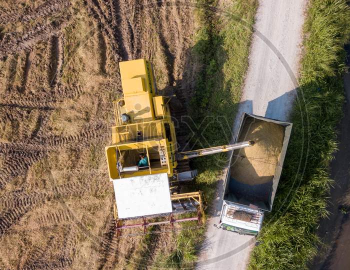 Aerial View Harvester And Truck At Paddy Field