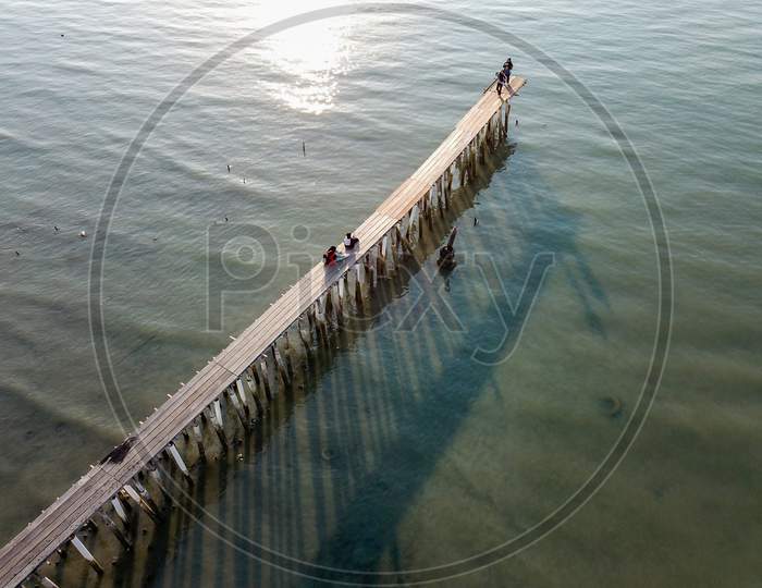 Aerial View Look Down Wooden Bridge With Shadow At Clan Jetty