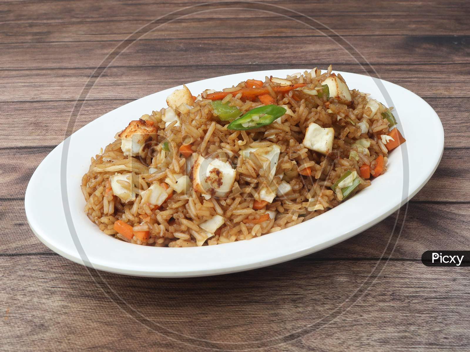 Healthy And Tasty Paneer Fried Rice Made Of Rice, Mixed Veggies And Paneer, Served In Bowl Over A Rustic Wooden Background, Indo Chinese, Indian Cuisine, Selective Focus