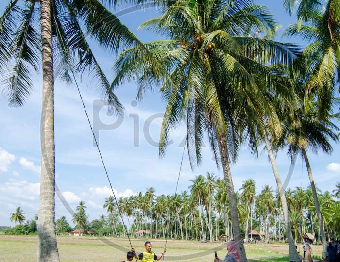 Tourist Play Swing In Kampung Agong