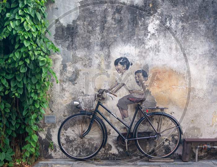 Little Children On A Bicycle Painted By Ernest Zacharevic