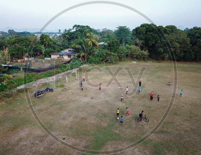 Local Kids Play In Football Field