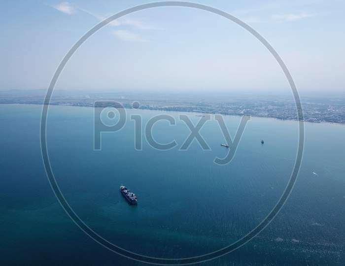 A Container Ship At Penang Sea. Back Is Peninsular Malaysia