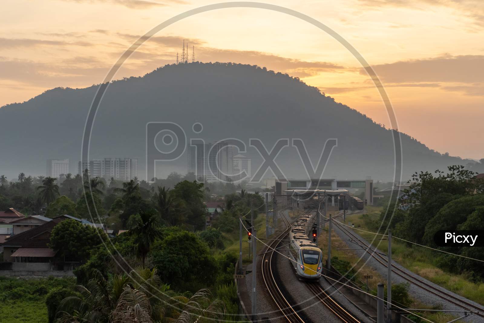 A Train Move From Train Station. Background Is Hill