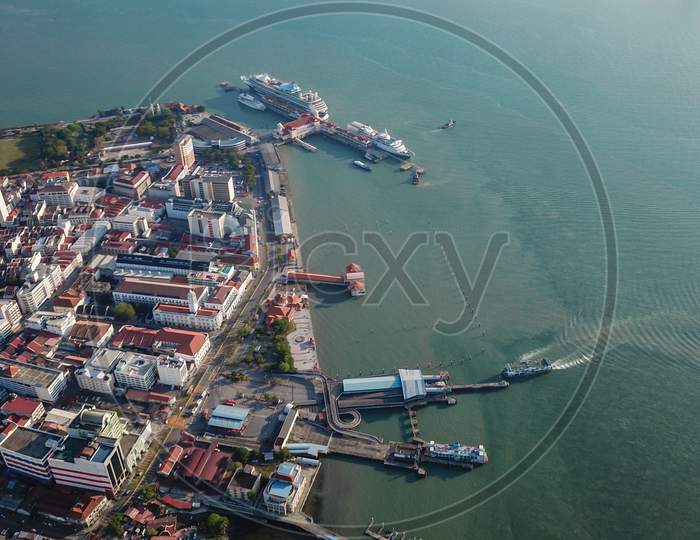 Aerial View Ferry Arrive Penang Jetty. Background Is Cruise Ship Visit Penang
