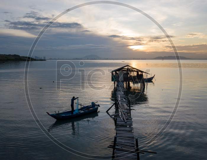 Fisherman Cast Net Beside Jetty
