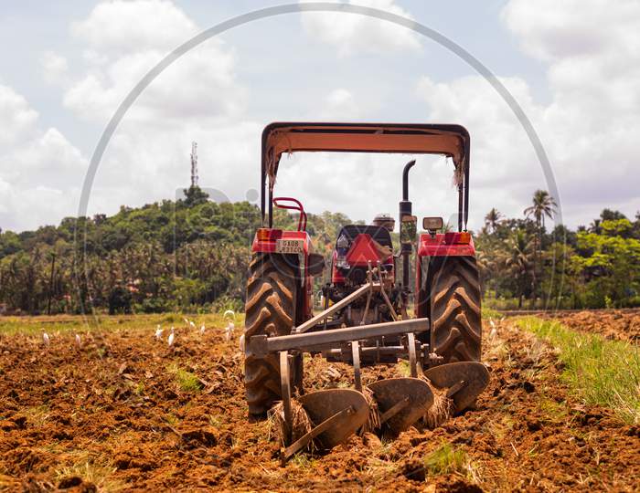 Curtorim, Goa/India- May 22 2020:  Tractor and tiller, plower used in agriculture Machinery used in the field for paddy cultivation/Agricultural scene in Goa,India