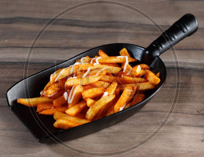 Tasty Spicy Peri Peri French Fries Served Over A Rustic Wooden Background, Selective Focus