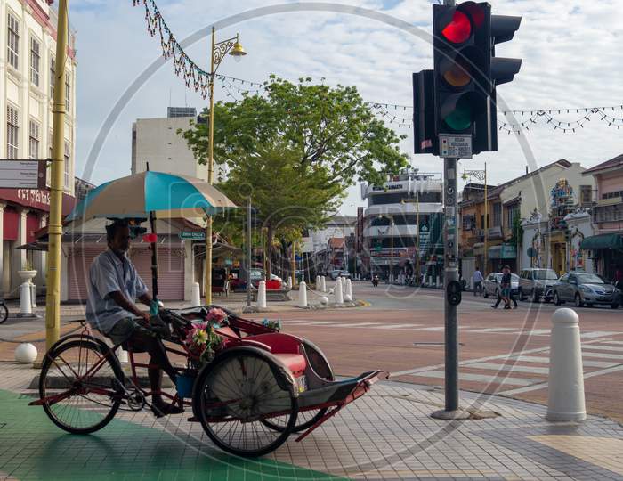 Rickshaw Driver Wait At Traffic Light