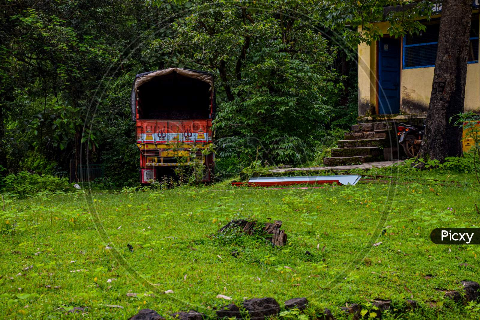 Picture Of A Truck Parked In A Dense Green Forest In India.
