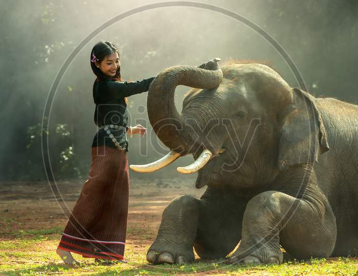 Beautiful African girl and Asian elephant