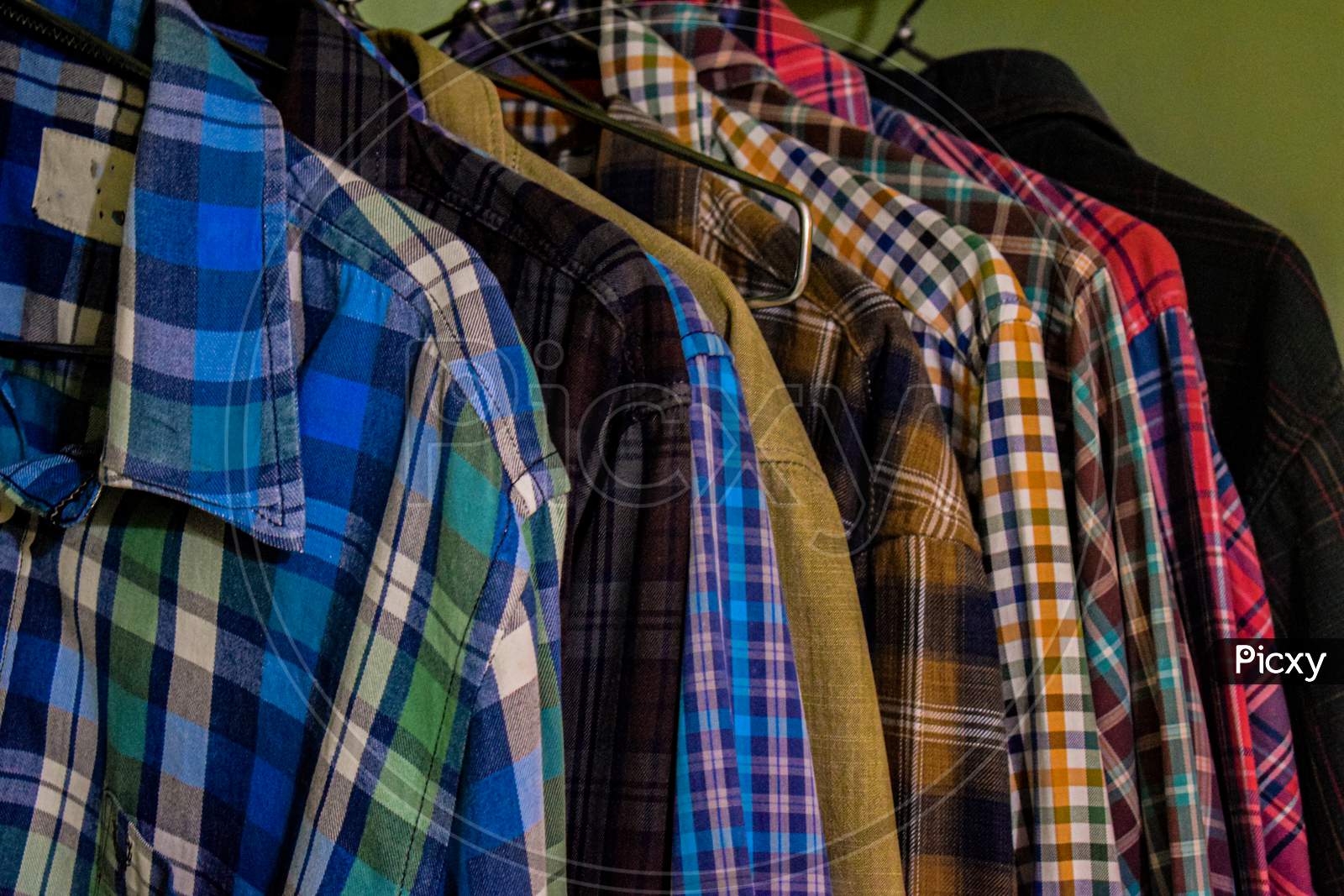 Collection Of Different Types And Colors Of Men Shirts In Wardrobe.
