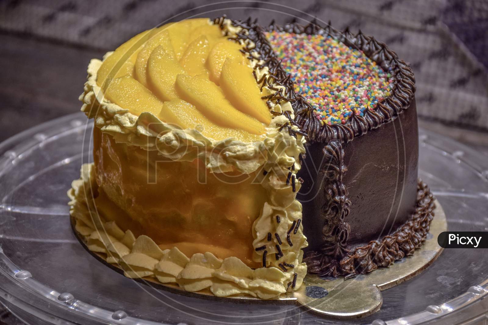 Dark Chocolate Cake Decorated With Mangoes - Kaveri's Cake Hut | Facebook