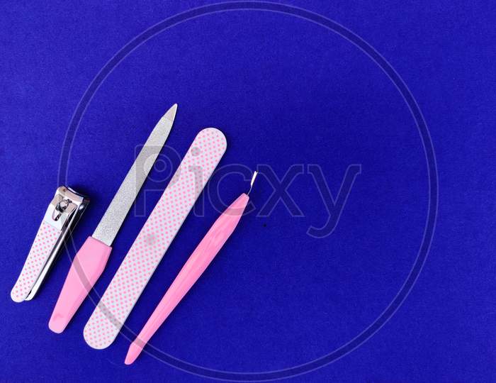 Copy Space Of Manicure Tools Isolated On Blue Background.
