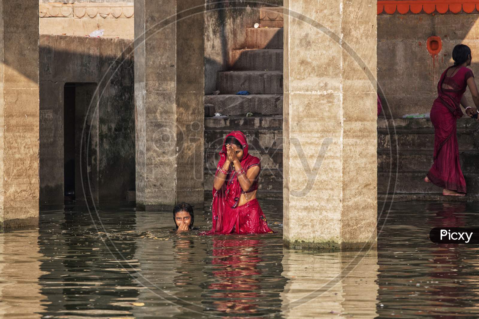 Image Of Unidentified Hindu Women Pilgrims Take Bath In The Holy River