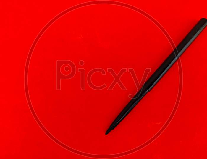 Copy Space Of Kajal Pencil Isolated On Red Background.
