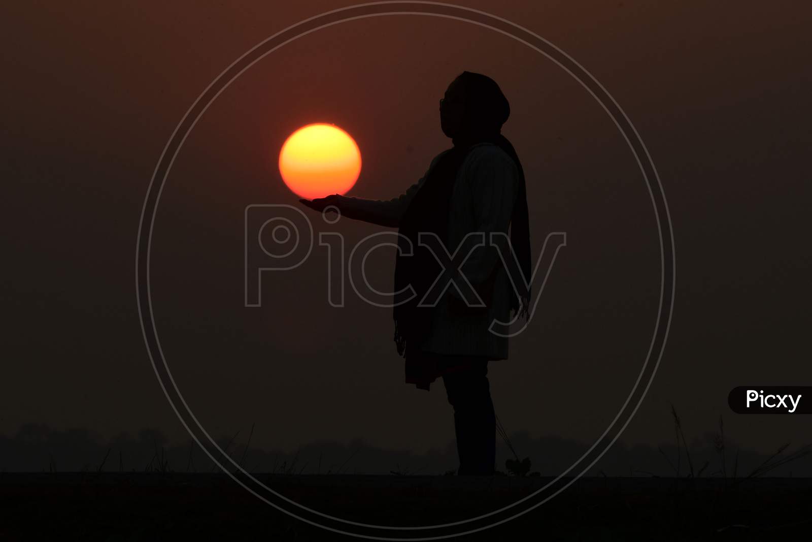 A girl enjoy the last sunset of the year in  Assam on Dec 31,2020