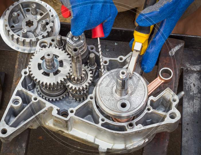 A Motorcycle Engine with Crankshaft,gears,bearings are being Assembled after due clean up at a 2 wheeler  Garage in Mysuru,India.