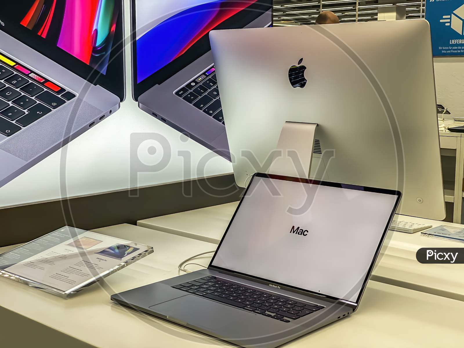 Darmstadt, Germany - September 16th 2020: A German photographer visiting Loop5, the biggest shopping mall in Hesse, taking pictures of the new MacBook Pro from Apple in a Saturn market.