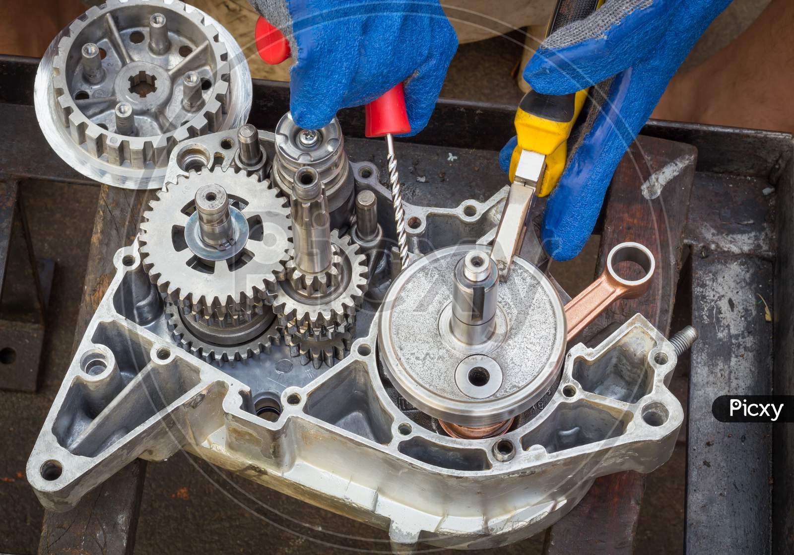 A Motorcycle Engine with Crankshaft,gears,bearings are being Assembled after due clean up at a 2 wheeler  Garage in Mysuru,India.