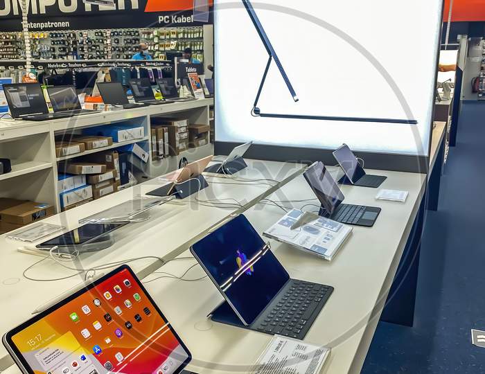 Darmstadt, Germany - September 16th 2020: A German photographer visiting Loop5, the biggest shopping mall in Hesse, taking pictures of the new iPad Pro Pro from Apple in a Saturn market.