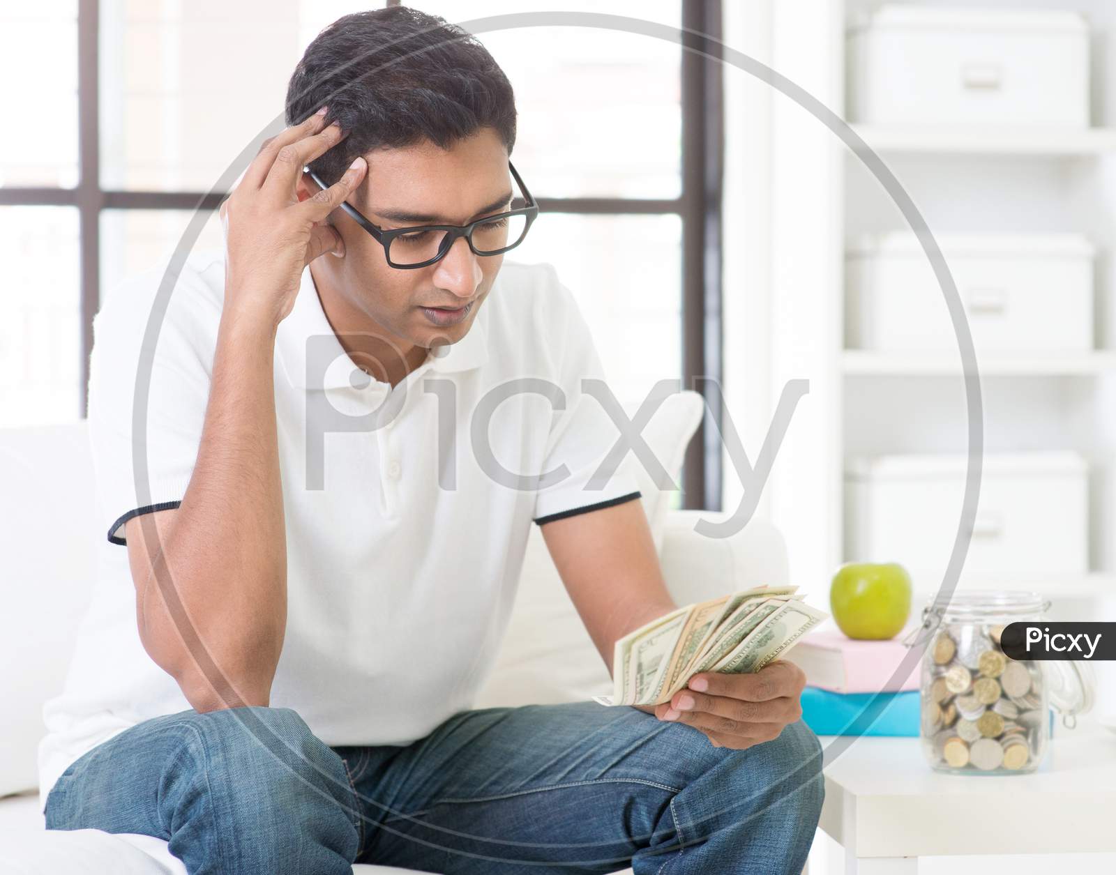 Stressed Indian Guy Counting Money