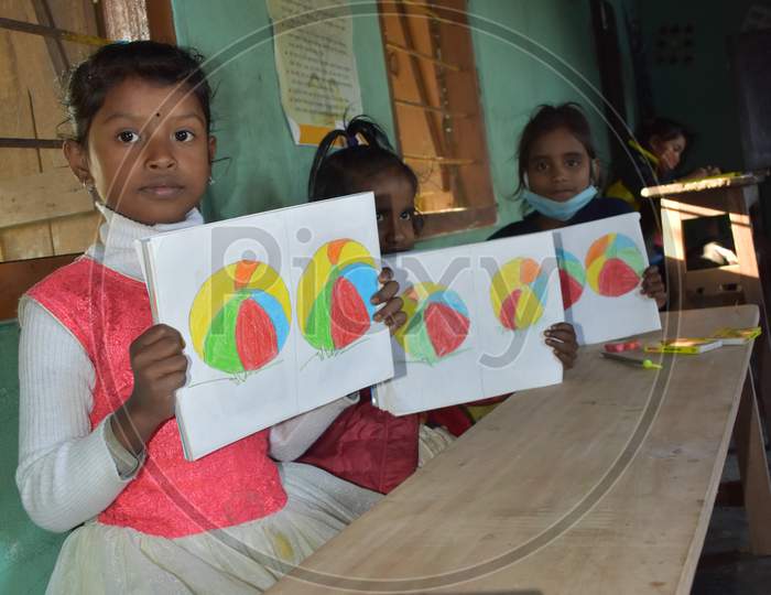 VILLAGE STUDENT IN A ART  SCHOOL OF ASSAM,INDIA .STUDENT TAKING THEIR DRAWING BOOK IN A HAND