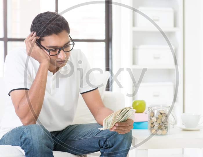 Unhappy Indian Guy Counting Money