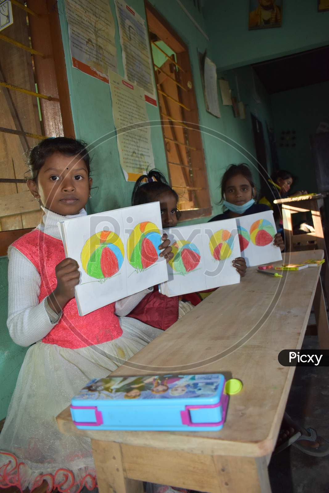 VILLAGE STUDENT IN A ART  SCHOOL OF ASSAM,INDIA .STUDENT TAKING THEIR DRAWING BOOK IN A HAND