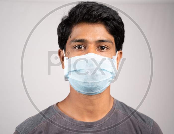 Young Man Properly Covered Nose And Mouth With Face Mask - Awareness And Safety Concept To Ware Mask Properly, To Protect From Coronavirus Or Covid-19 Crisis On Isolated Background.