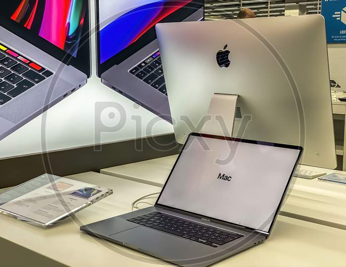 Darmstadt, Germany - September 16th 2020: A German photographer visiting Loop5, the biggest shopping mall in Hesse, taking pictures of the new MacBook Pro from Apple in a Saturn market.