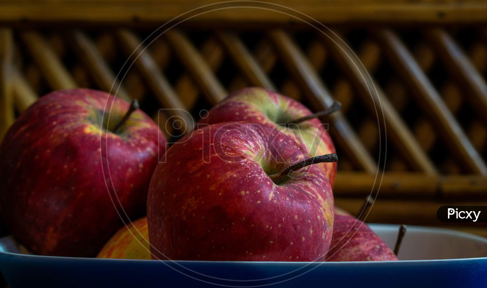 A Bunch Of Healthy Apples Stacked Together In A Bowl