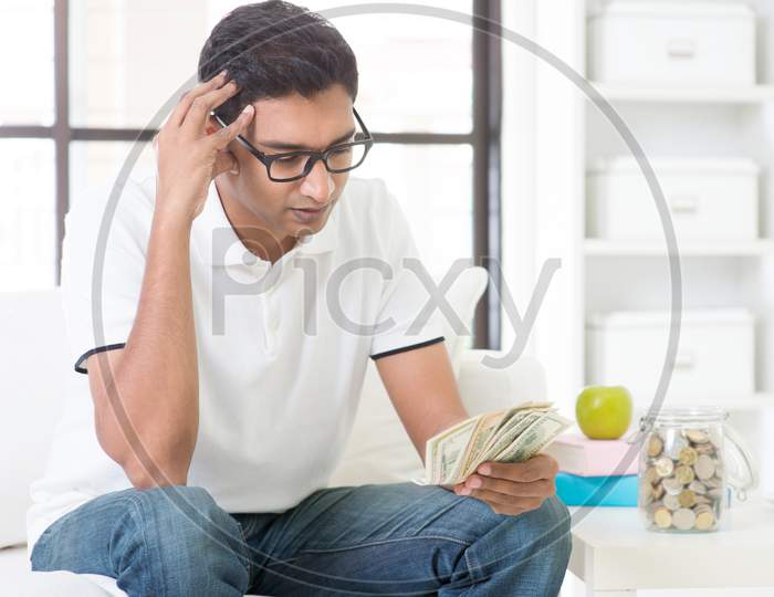 Stressed Indian Guy Counting Money