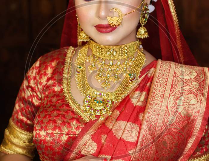 Portrait Of Very Beautiful Indian Bride Holding Traditional Wooden Sindur Or Sindoor Box In Hand, Wedding Symbol Sindoor Box.