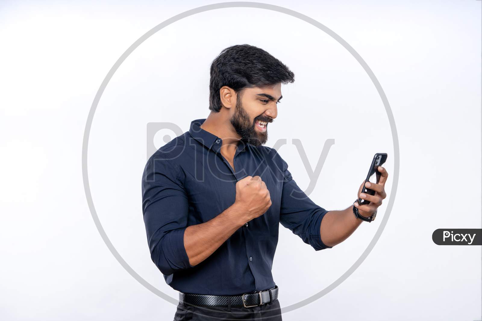 Indian man expressing excitement while using mobile
