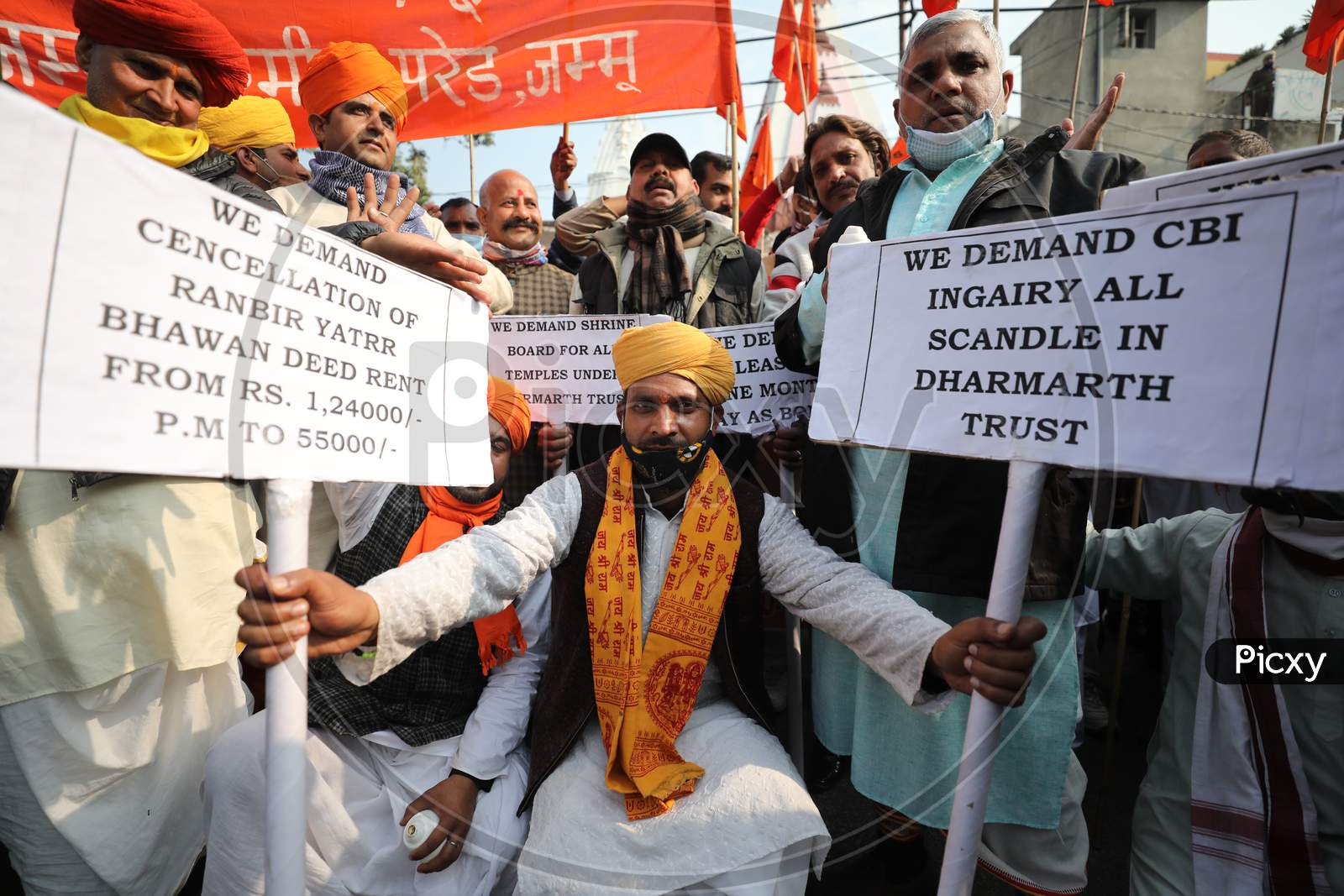 Members of Dharmarth trust, which is managing the affairs of various temples, holding a demonstration outside Raj Bhavan in Jammu in support of their various demands including its merger with Shri Mata Vaishno Devi Shrine Board and enhancement of salaries. 5,Dec,2020.