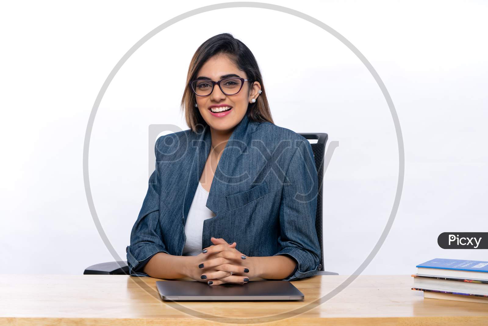 Smiling Indian confident young woman working with a Laptop